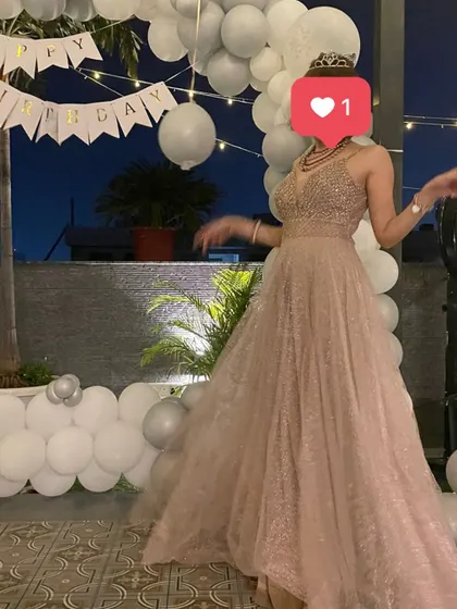 The birthday girl looking radiant in her princess gown. The all-white balloon decor and 'Happy Birthday' banner created a dreamy, ethereal backdrop for her special day.