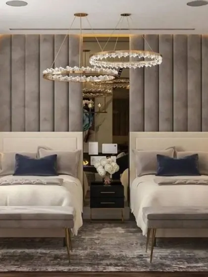 A great solution for a shared or guest bedroom, this design features two separate beds with a continuous upholstered back panel. The matching ring chandeliers add a touch of symmetrical elegance.