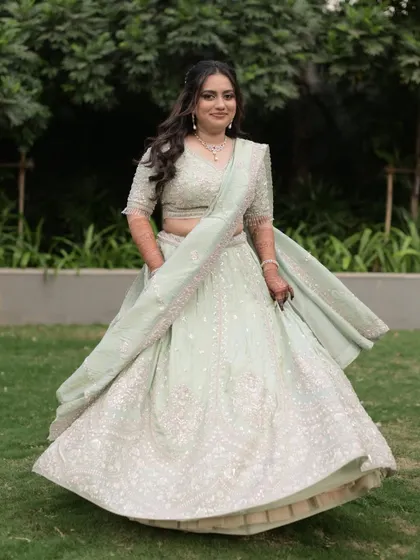 A full length shot of Vidhi twirling in her gorgeous lehenga. The makeup completes her elegant and modern engagement look.