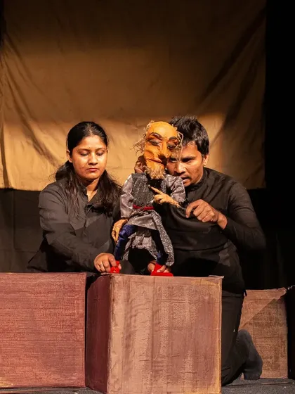 Puppeteers manipulate a small rod puppet of a Lilliputian character, contrasting with the giant scale of Gulliver. The show teaches that it's not your size, but how big you are on the inside that counts.