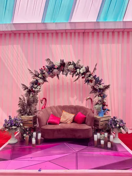 We created this fun photo booth with a plush pink sofa, a beautiful floral arch, and quirky flamingo props, making it a popular spot for guests at the Sangeet.