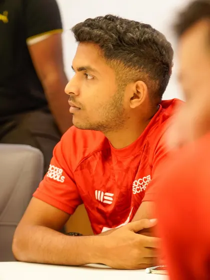 A coach listens intently during a tech orientation session. We are committed to using modern tools to enhance our coaching.