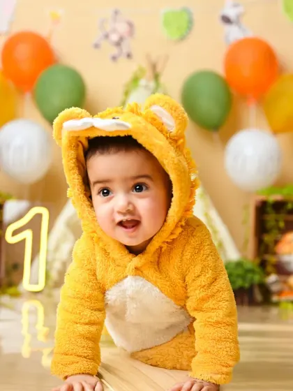 Dressed in a fuzzy lion costume, this little cub is the king of our jungle-themed photoshoot.