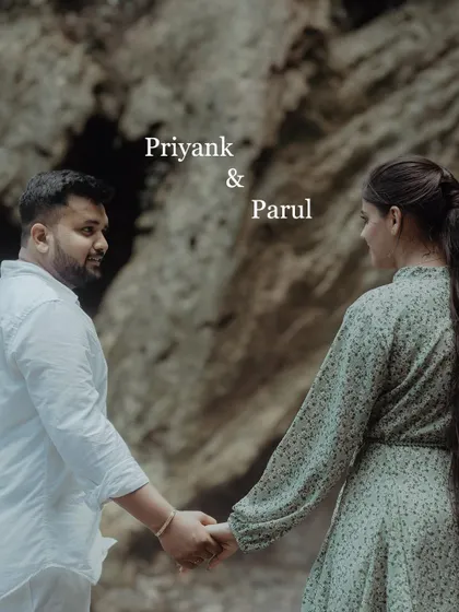 A simple and sweet pre-wedding photo of the couple holding hands, with the focus on their connection and the beautiful natural textures of the location.