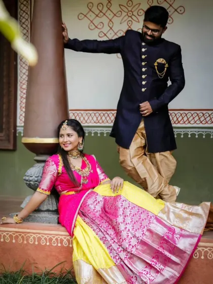 A playful moment captured during a traditional pre-wedding shoot. I styled the couple in this vibrant pink and yellow half-saree and a complementary dark sherwani for the groom.