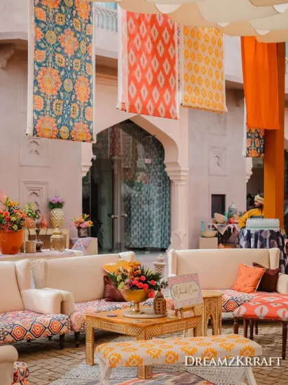 Lounge seating at the Soukh Mehendi, with patterned fabrics and hanging textiles creating a layered and authentic bazaar feel.