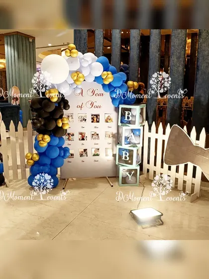 Another take on the Boss Baby milestone board, this time set against a white picket fence with a large bowtie prop.