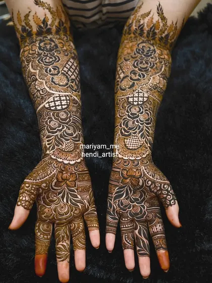 A beautiful floral bridal mehendi with fire-like patterns at the top for a unique touch.