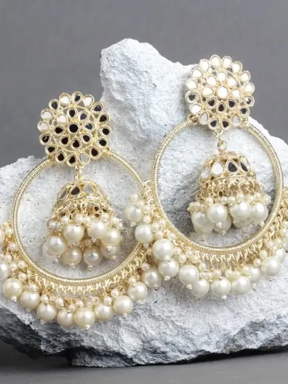 The timeless elegance of white pearls. Our mirror work chandbali hoops in a classic pearl version, perfect for any traditional outfit.