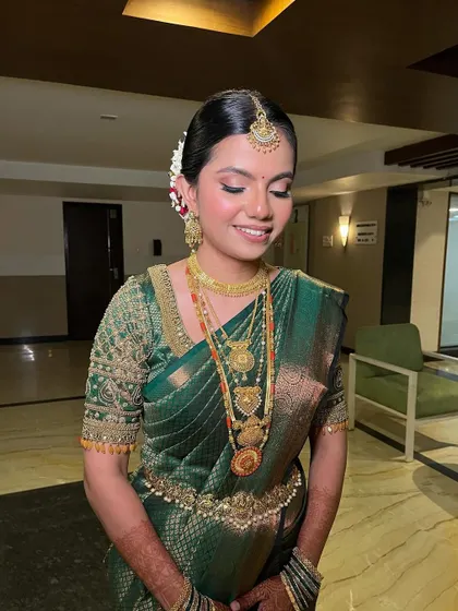 A close-up of the bride's happy face. The makeup is fresh and radiant, enhancing her natural beauty and her joyful expression.