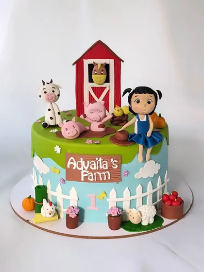 Old MacDonald had a farm! A fun and colorful farm-themed cake for a first birthday, complete with a barn, a little farmer girl, and all her animal friends.