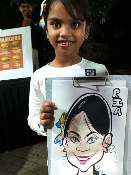 Another happy young guest at a night market. Her bright smile is reflected in the cheerful caricature I drew for her.
