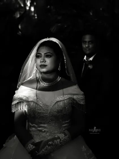 A dramatic black and white portrait of the bride, her face illuminated, creating a timeless and artistic image.
