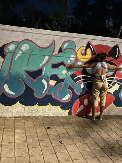 Embracing my creation. This is more than just paint on a wall; it's a piece of my heart and energy given to the city.