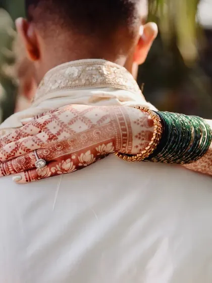 A duplicate of 190, this close-up beautifully captures the detail of the henna stain and the bride's ring.