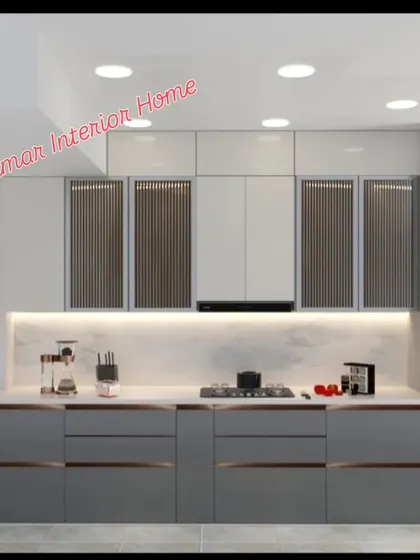 Another view of the grey kitchen, showing the extensive drawer storage and a tall unit for a built-in oven.