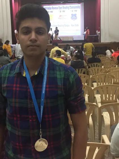 A close-up of a student with his medal at the Indian Revenue Open Shooting Championship.