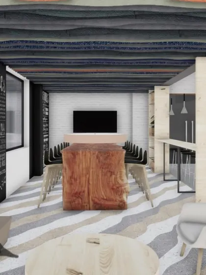A render of a lounge area within the JIM Jaipur canteen, featuring a large chalkboard wall for announcements or creative expression, alongside comfortable seating and a communal table.