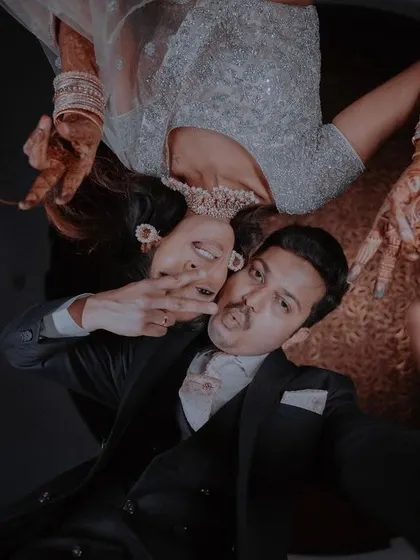 A fun and quirky upside-down selfie of the couple, showing their playful side during the reception party.