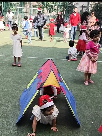 Crawling through a play tunnel during the Christmas carnival. This is a fun gross motor activity that was part of our festive obstacle course.