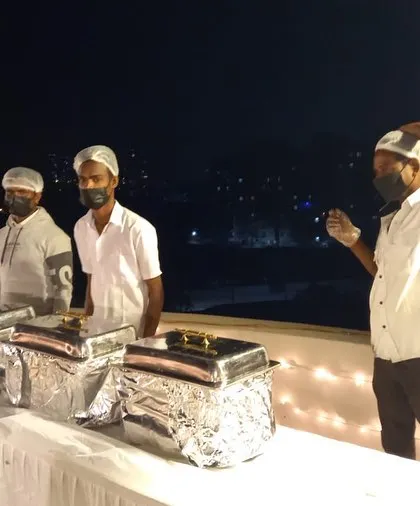 An evening dinner buffet arranged on a client's rooftop. Our team is equipped to handle outdoor catering, ensuring a professional setup with proper food handling and service, no matter the location.