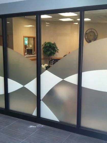 A repeat of the wavy, abstract frosted film design, showcasing its ability to add a fluid, artistic element to a professional space.
