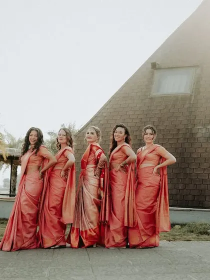 The bride's entourage, serving looks. A stylish group photo of the bride and her bridesmaids in matching sarees.
