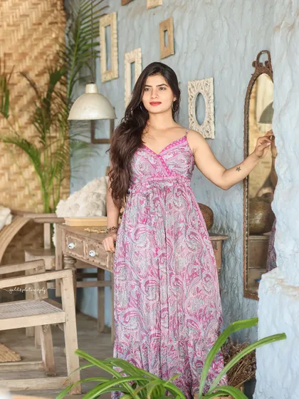 A collection of relaxed, bohemian-style portraits taken at a rustic cafe. The model is featured in a flowing paisley dress, interacting with props like a guitar, creating a natural and artistic vibe.