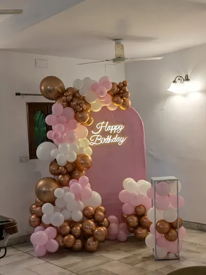 A wider view showing the pink and rose gold setup in a home environment, complete with a pool table in the background. We can set up a party anywhere!