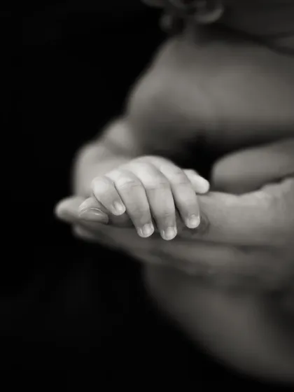 A different angle of the baby-holding-finger shot, this time in black and white against a dark background for a more dramatic effect.