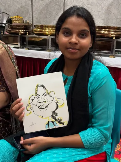 A guest at a get-together, happy with her exaggerated and fun portrait.
