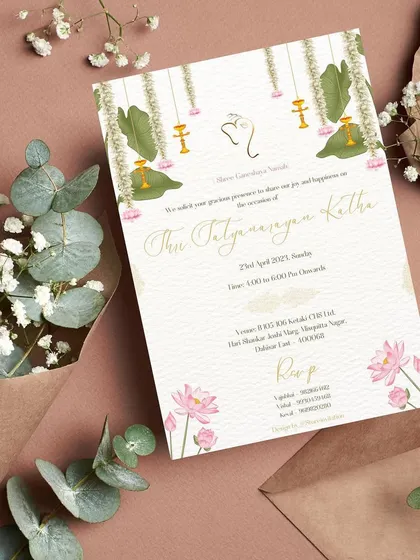 The invitation for the Shri Satyanarayan Katha is stunning with its white texture background and gorgeous lotus and leaf embellishments.🪷