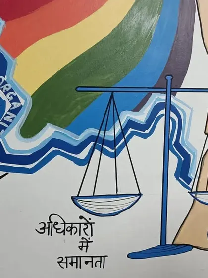 A close-up of the section representing equality in rights, with the scales of justice and the Hindu Code Bill. This mural is filled with symbols of important social movements.