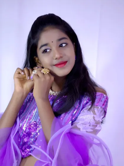 A close-up shot highlighting the jewelry and details of a purple party-wear lehenga.