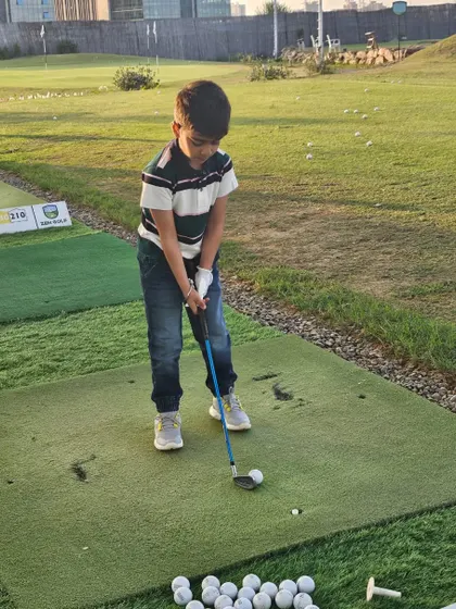 A young champion in the making, taking his first swing on his birthday. It's a wonderful way to introduce kids to a new sport in a fun, no-pressure environment.