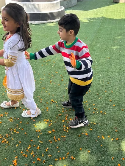 The joy of Holi is in sharing colors and smiles. Here, two friends playfully apply flower-petal colors to each other during our safe and natural Holi celebration.