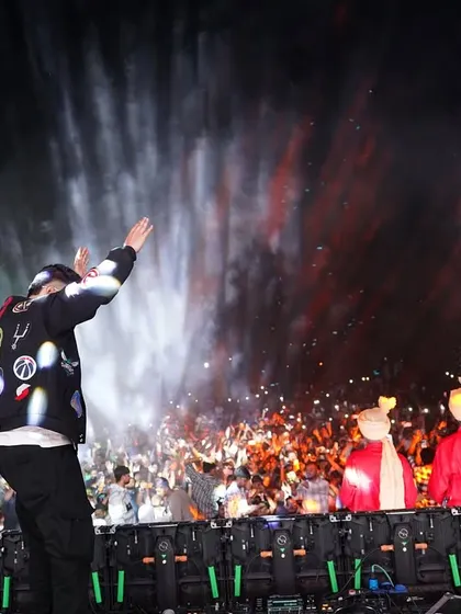 A special moment at a show with traditionally dressed performers on stage, blending culture with modern concert effects.