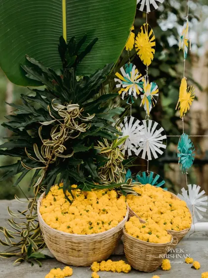 Baskets of fresh marigolds and paper pinwheels create a fun and colorful decor detail for a vibrant celebration.