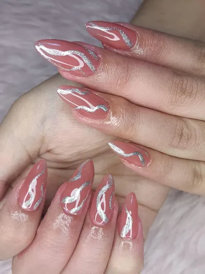 A unique design with a dusty rose base and abstract silver glitter swirls.