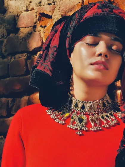 This is a shot from a jewelry shoot I styled for a homegrown brand, where I also modeled. The look layers a traditional head covering and a statement silver necklace over a simple red top for a rustic, earthy feel.