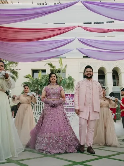 A Bridgerton-themed entry fit for a duke and duchess. The couple is escorted by violinists and royal guards, creating a scene straight out of a Regency romance.