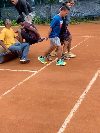 Even when it rains, we find ways to have fun. Teamwork makes the dream work, even when it comes to rolling the court.