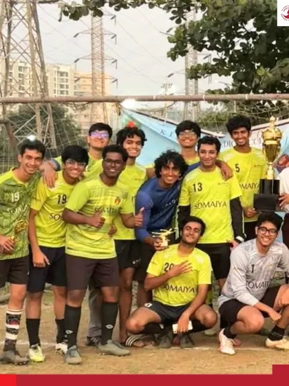 The entire team celebrates their championship win at the Vanquish 2026 football tournament, posing with their trophy.