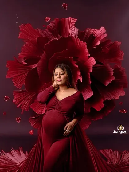 A powerful and artistic portrait using a giant red paper flower as a backdrop. This creates a dramatic and high-fashion look.