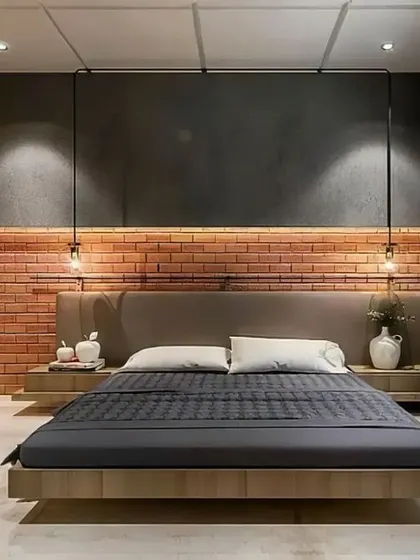 An industrial-chic bedroom with an exposed brick accent wall and a floating wooden bed frame. The open-concept wardrobe adds to the raw, urban aesthetic.