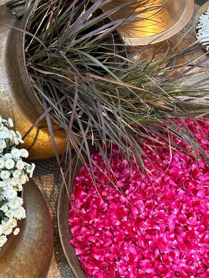 A close-up of the details, showing pink and white flowers in brass pots.