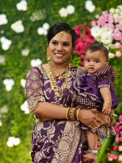 Another sweet moment between mother and daughter, with a beautiful floral backdrop.