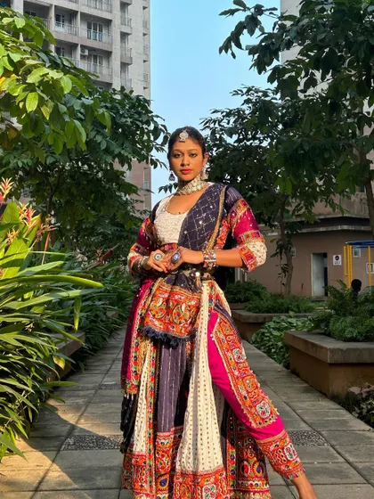 A full-length view of this unique Indo-western Garba outfit, which pairs a traditional embroidered top with dhoti-style pants for a modern twist.