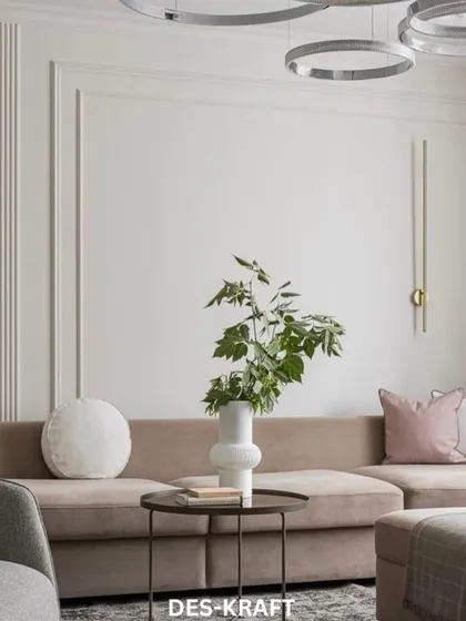 The plush sofa is adorned with simple, elegant cushions, creating a perfect spot for relaxation. The vertical wall sconce adds a touch of artistic flair.