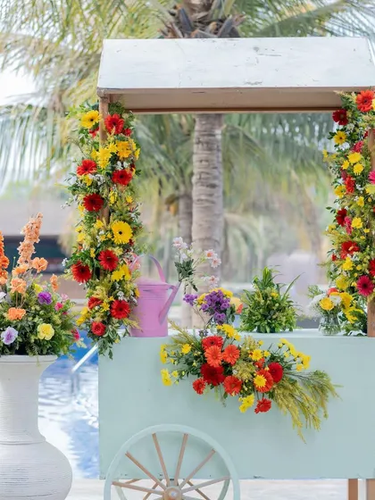 A charming floral cart, part of the decor for the 'Carnival of Love' theme, adding a whimsical and pretty touch to the space.